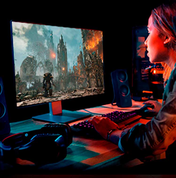 Ung gamer spelar actionspel på en high-performance skärm med RGB-tangentbord, högtalare och headset på skrivbordet.